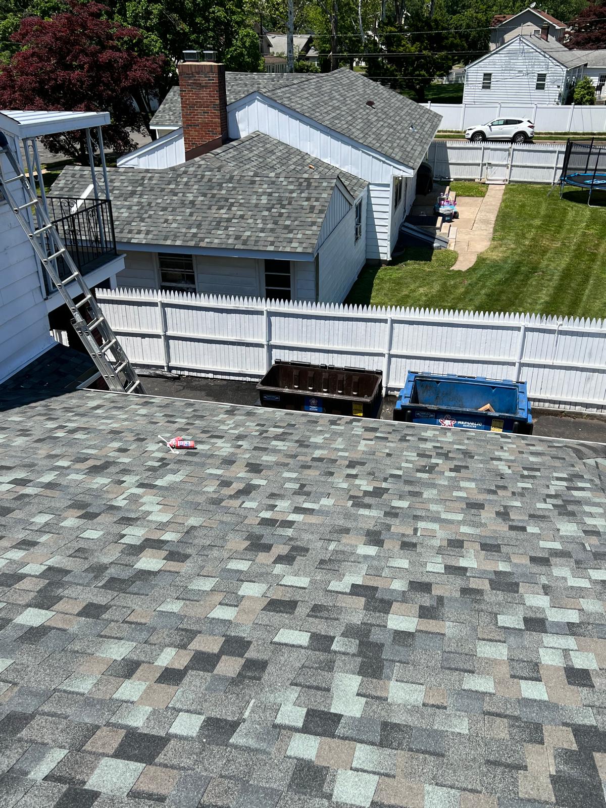 Completed asphalt shingle roof, aerial view of the property
