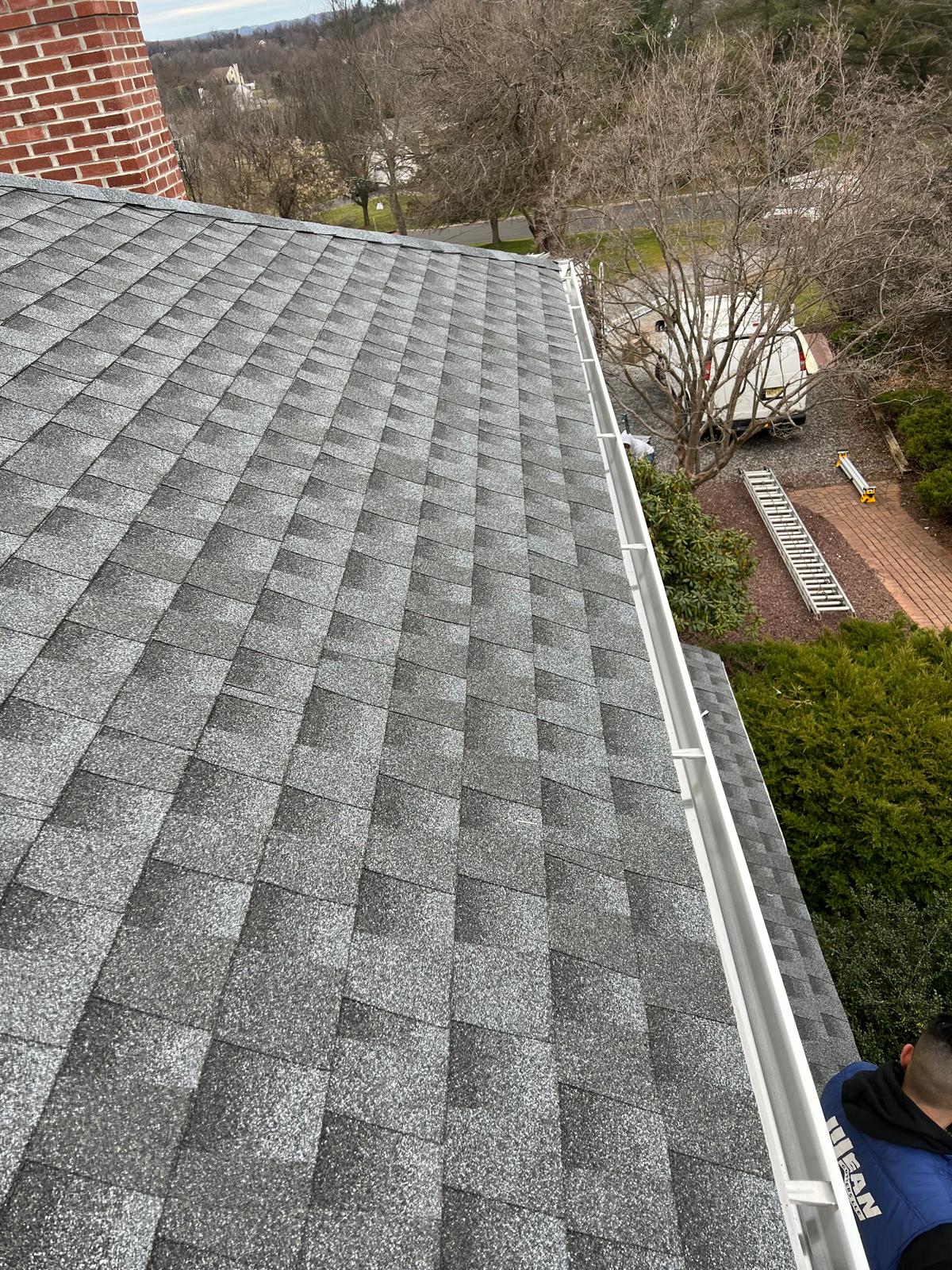 Close-up of new architectural shingles and metal flashing